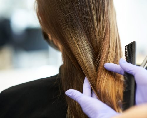 Picture of adult woman at hairdresser wearing protective mask due to coronavirus pandemic